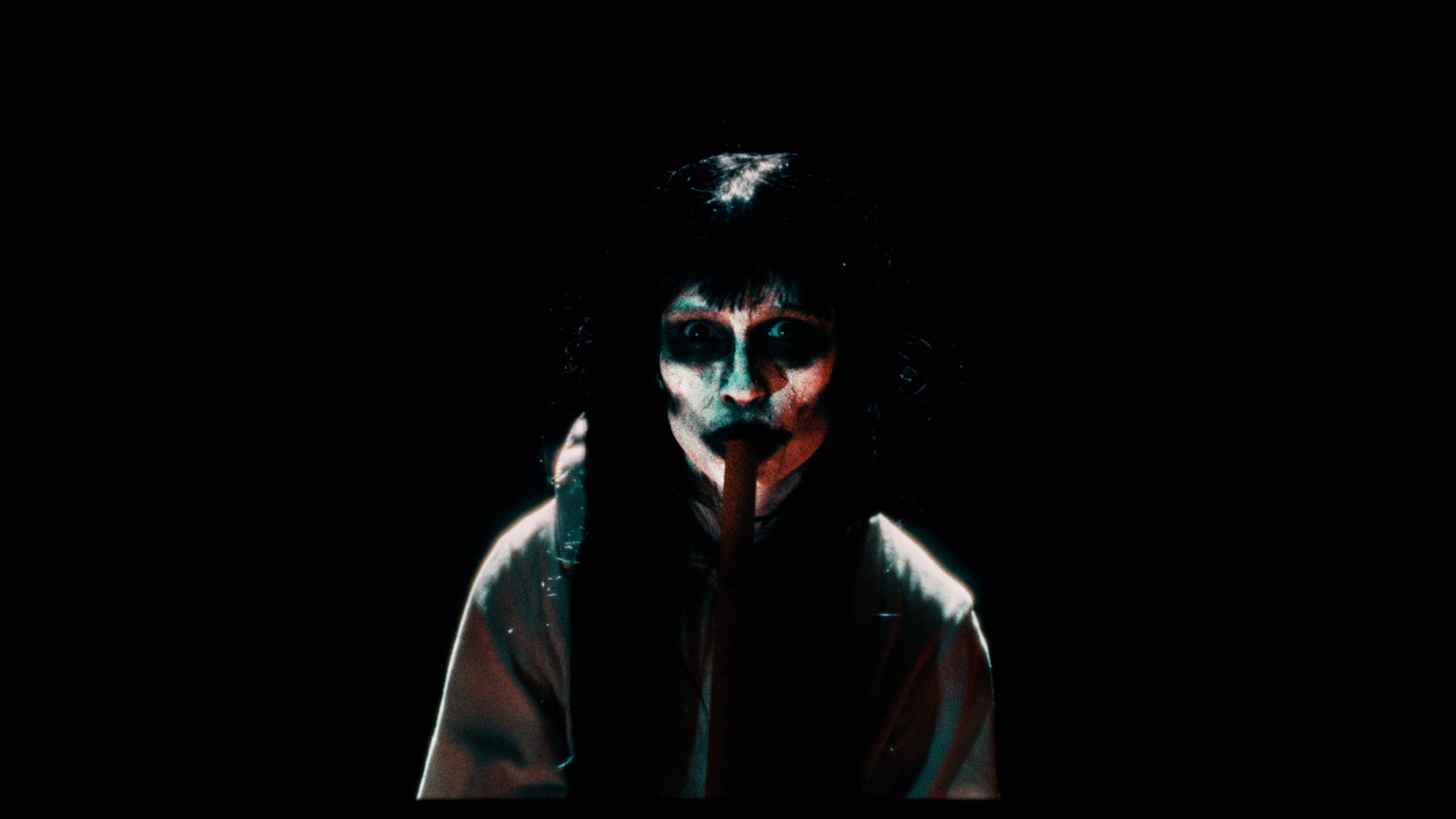 A mask-wearing woman playing the flute.