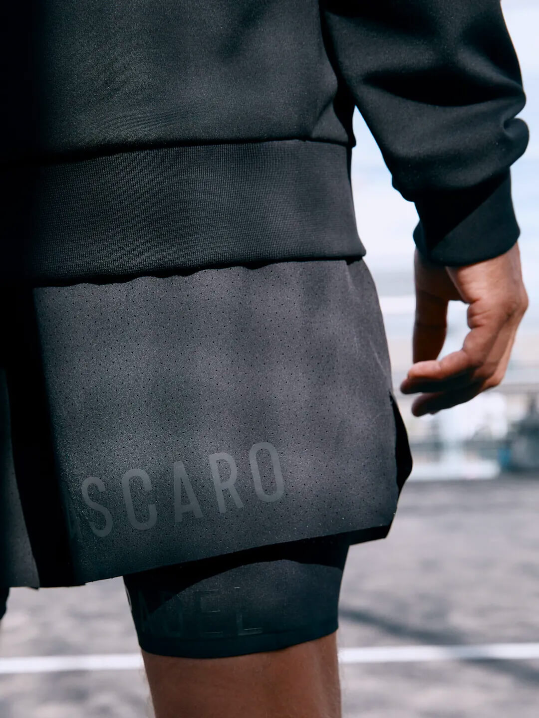 A close-up of a person wearing Ascaro branded clothing.