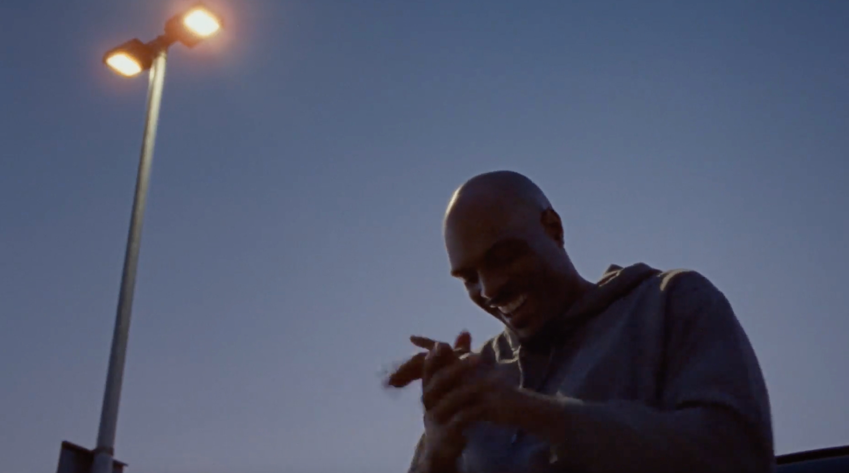 A smiling man clapping his hands