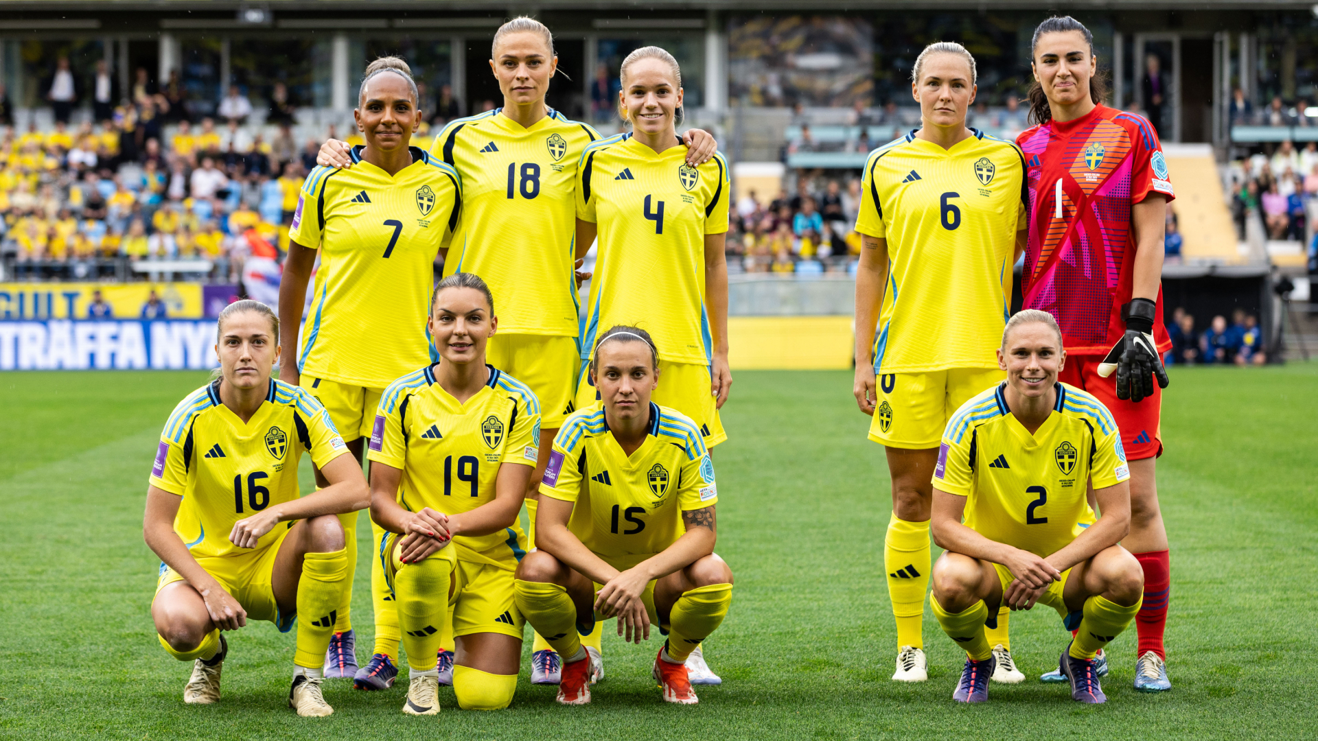 A group photo of nine football players with a gap in-between them.