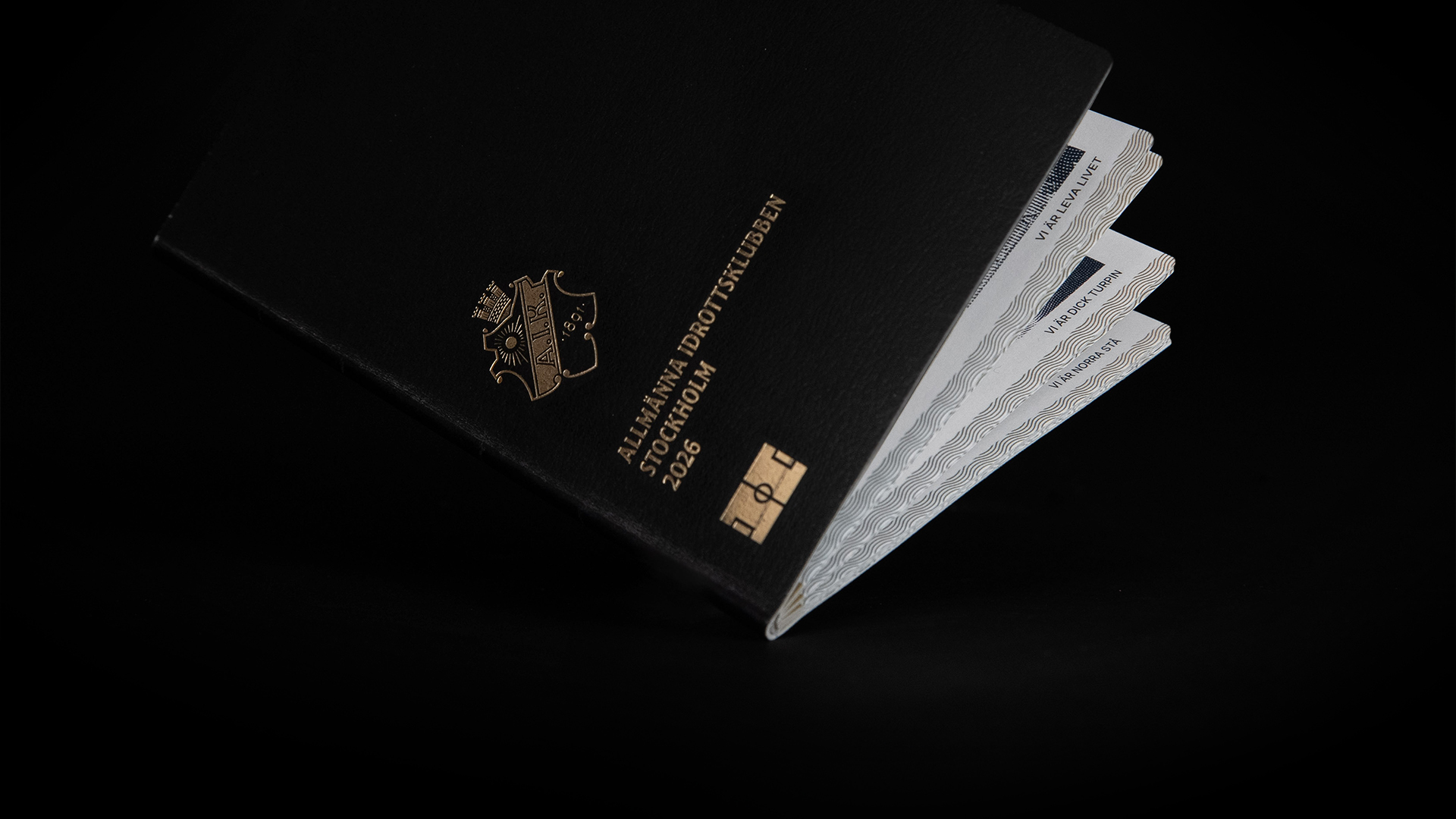 A close-up of a black passport with an AIK logo on the cover