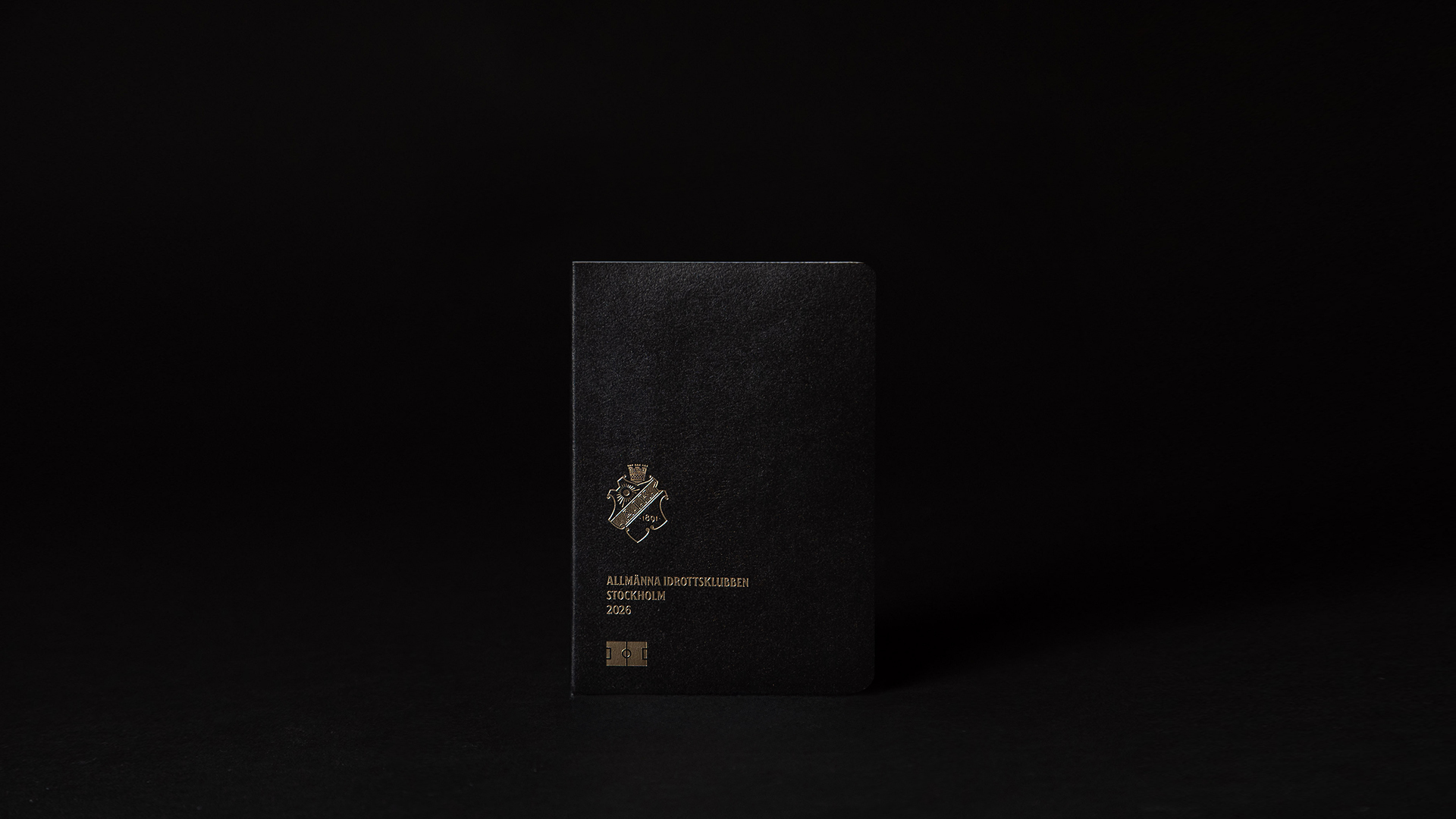 A black passport with an AIK logo on the cover